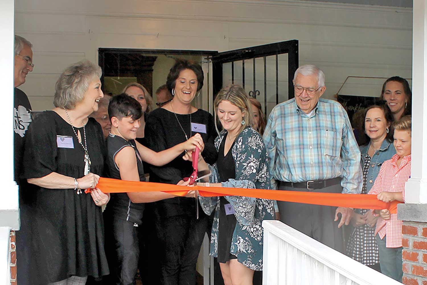 Jessica Williams (center) joined by family and friends cuts the ribbon marking the opening of Hope House, a residential Christian Restoration & Transformation Program for women recovering from drug addiction. (MNJ photos/ Rachel Hoskins)  