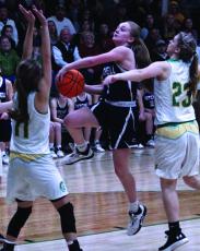 Mitchell senior Jill Pittman drives to the basket and avoids a pair of Alleghany defenders in a postseason road game this past season. Pittman, who helped the Mountaineers finish 22-6 and win four playoff games, now has two college offers from schools in Georgia.  (MNJ file photo)