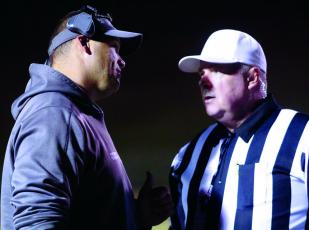 Mitchell High School head varsity football coach Travise Pitman talks things over with an official during a 2019 state playoff game. Pitman and his team will return to play in February. (MNJ file photo)